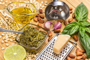 Ingredients for homemade pesto. Parmesan cheese on grater. Lemon and leaves, basil and oil. Garlic...