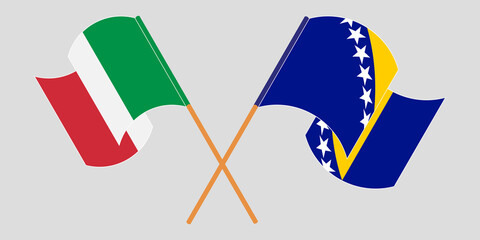 Crossed and waving flags of Italy and Bosnia and Herzegovina