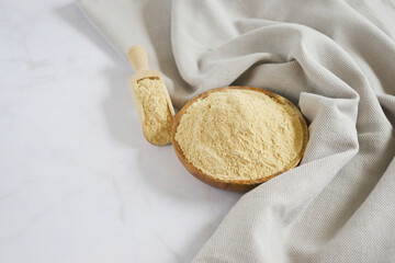 Powdered Maca or Peruvian ginseng in a wood bowl, lat. Lepidium meyenii