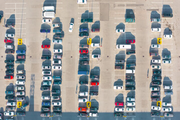 Aerial top down view of the parking lot with many cars of supermarket shoppers in the city grocery...
