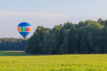 Hot air balloon over the countryside in summer, banner