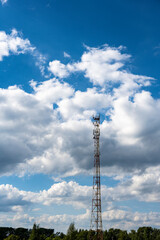 Obraz premium technical tower against a blue sky with clouds