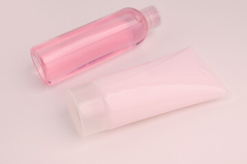 Cosmetics for beauty and hair care. Cleansing shampoo and nourishing and regenerating conditioner in a tube on a pink background