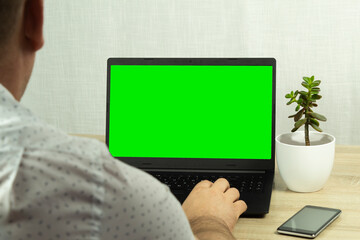 A man looks into a computer monitor