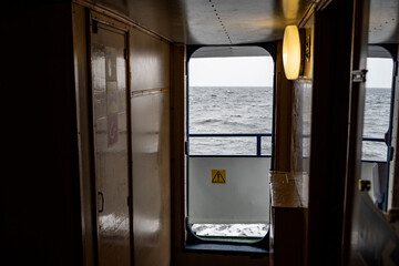 open door on a ship with sea and gray clouds