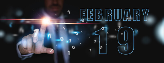 february 19th. Day 19 of month,advertising or high-tech calendar, man in suit presses bright virtual button winter month, day of the year concept