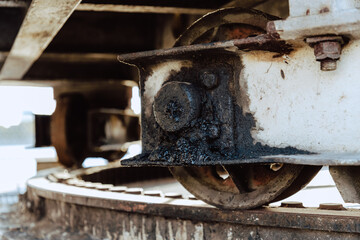 Detail shots of the runner and gear wheel of an old, rusty harbour crane
