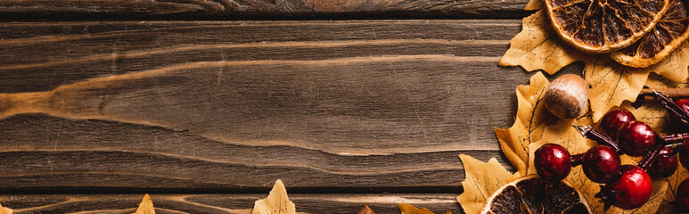 top view of autumnal decoration on brown wooden background, panoramic shot