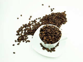 Roasted coffee beans in a white cup on a white plate as a background