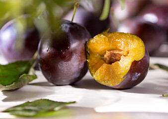 Blue violet fruit background with ripe tasty sweet plums from garden