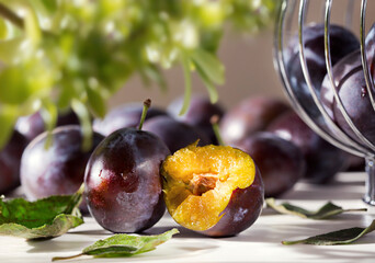 Blue violet fruit background with ripe tasty sweet plums from garden