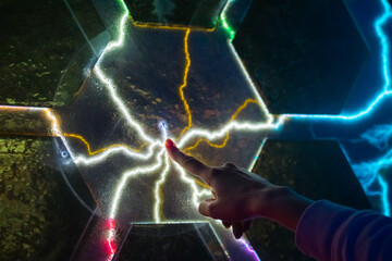 Electricity, education, science, futuristic and physics concept. Woman touching plasma panel...