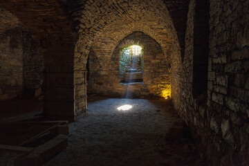Obraz premium Rays of light shining into the medieval cellar
