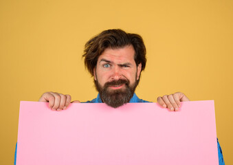 Advertising board and sale. Bearded man holding advertising board. Online shopping. Advertising banner. Seasons sale. Discount. Black friday. Marketing. Add. Copy space for text.