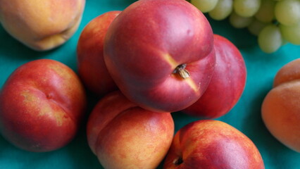 Fototapeta na wymiar Nectarines, peaches, green grapes close-up.