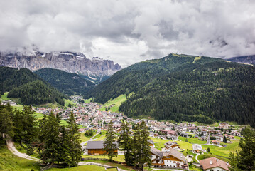 Fototapeta na wymiar commune Sëlva (Wolkenstein or Selva di Val Gardena) in the Val Gardena in South Tyrol, northern Italy - aerial view during late summer 