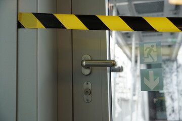 A detail of closed door and blocked with barrier tape to the terrace that is being reconstructed...