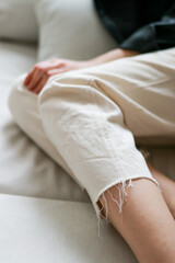 Obraz na płótnie Canvas Closeup of a girls leg wearing beige pants