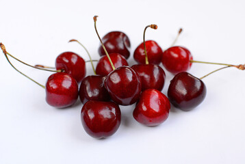 Large ripe berries of sweet cherry scattered on a white background