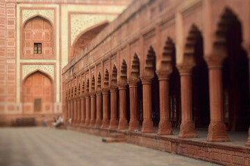 Fototapeta premium One of the buildings in Taj Mahal complex with arches and columns. Selective focus made with tilt-shift effect. Agra, Uttar Pradesh, India
