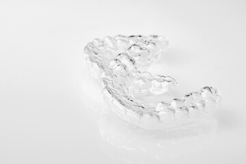 Two Invisible dental teeth aligners on the white background. Orthodontic temporary removable braces for fixing teeth after alignment. Therapy after brackets. 