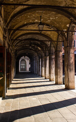 Sottoportico near Rialto with columns and vaulted ceiling without passersby. Venice, Italy.