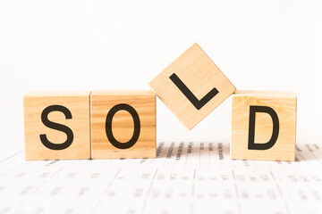Word sold. Wooden small cubes with letters isolated on white background with copy space available.Business Concept image.