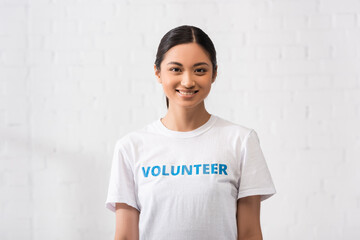 Asian volunteer looking at camera in charity center