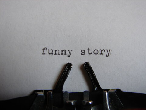 the words "funny story" written on a typewriter, close up