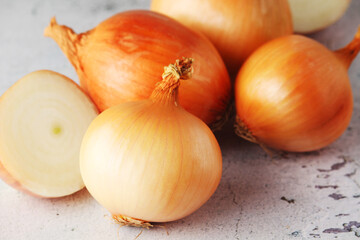 Golden onion bulbs on the table