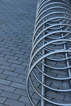 Stainless steel bicycle parking rack. Modern bicycle parking stand makes an abstract background.