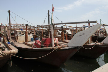 Fototapeta na wymiar Traditional dhows parked in the Fishing harbor of Bahrain