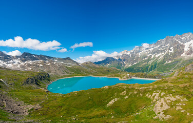 Artificial lake for hydroelectric power plant surrounded with mountains.
