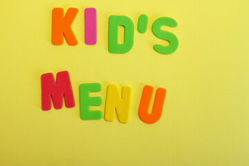 Kid's menu lettering, multicolored letters on color background, yellow green orange colors