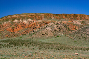 Clay-chalk hills of Kazakhstan with sparse vegetation.