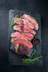 Traditional Commonwealth Sunday roast with sliced cold cuts roast beef with herbs and salt as top...