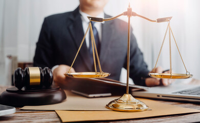 Business and lawyers discussing contract papers with brass scale on desk in office. Law, legal...