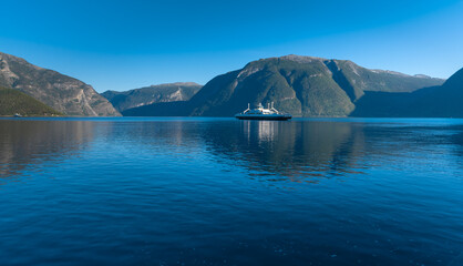 Fototapeta na wymiar Ferry crossing the Sognefjord, the largest and deepest fjord in Norway, between Kaupanger and Laerdal, Vestland, Norway