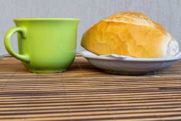 Breakfast in Brazil with traditional French bread, traditional Brazilian bread and green cup