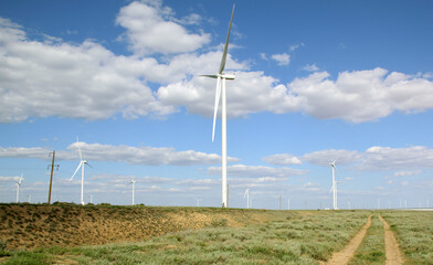 Wind farm on blue sky background with clouds 