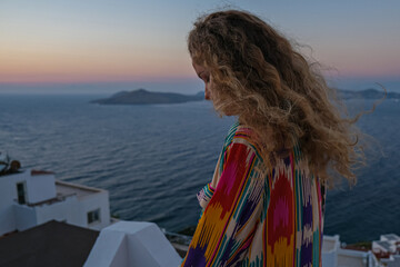 Fototapeta na wymiar beautifu woman at colorful sunset and sea view on background