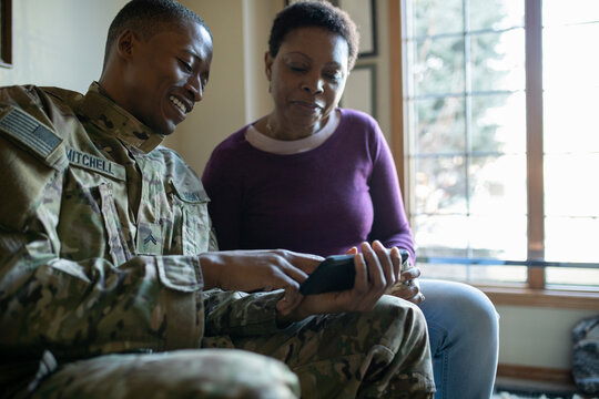 Army soldier and mother using smart phone