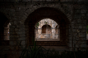 Fototapeta na wymiar Stari Grad/Croatia-August 7th,2020: Old stone arches around salt water pool in the atrium of 