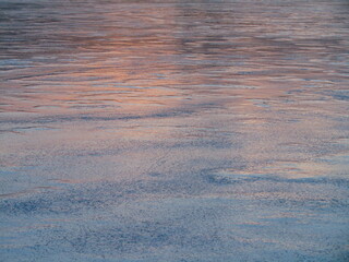 subtle blue orange sunset hue frozen ice with bubbles abstract