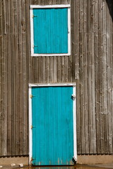Obraz na płótnie Canvas blue turquoise doors grey wood building