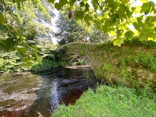 Old stone bridge, spanning the river near Ellers Lane in, Burton cum Walden, Leyburn, UK