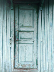 Turquoise wooden village cabin doors detail