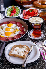 Traditional Turkish Breakfast with sausage egg pan on granite marble table.Close and large view.               