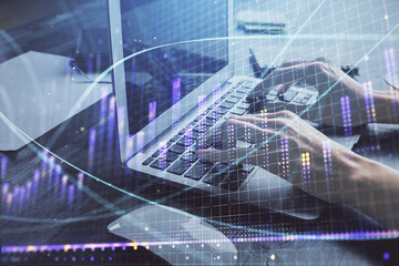 Double exposure of woman hands typing on computer and forex chart hologram drawing. Stock market invest concept.