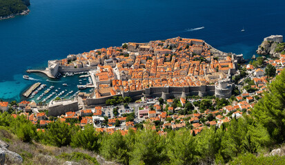 Fototapeta na wymiar Dubrovnik, Croatia. View on the old town from high mountain. Vacation and adventure. Top view rocks at on the old castle and blue sea. Panoramic landscape. Travel - image